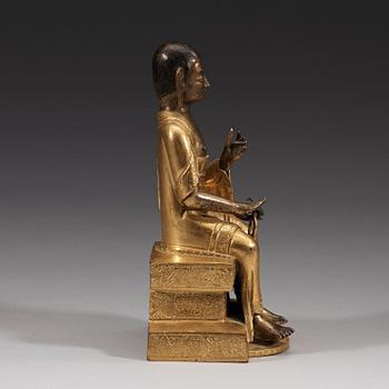 A part-gilt bronze figure of a Lohan, presumably Kalika, Tibeto-Chinese, 18th Century.