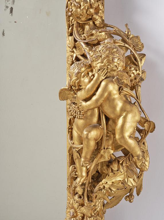 A presumably Dutch Louis XIV carved giltwood frame with mirror glass, in the style of Jean Le Pautre, late 17th century.