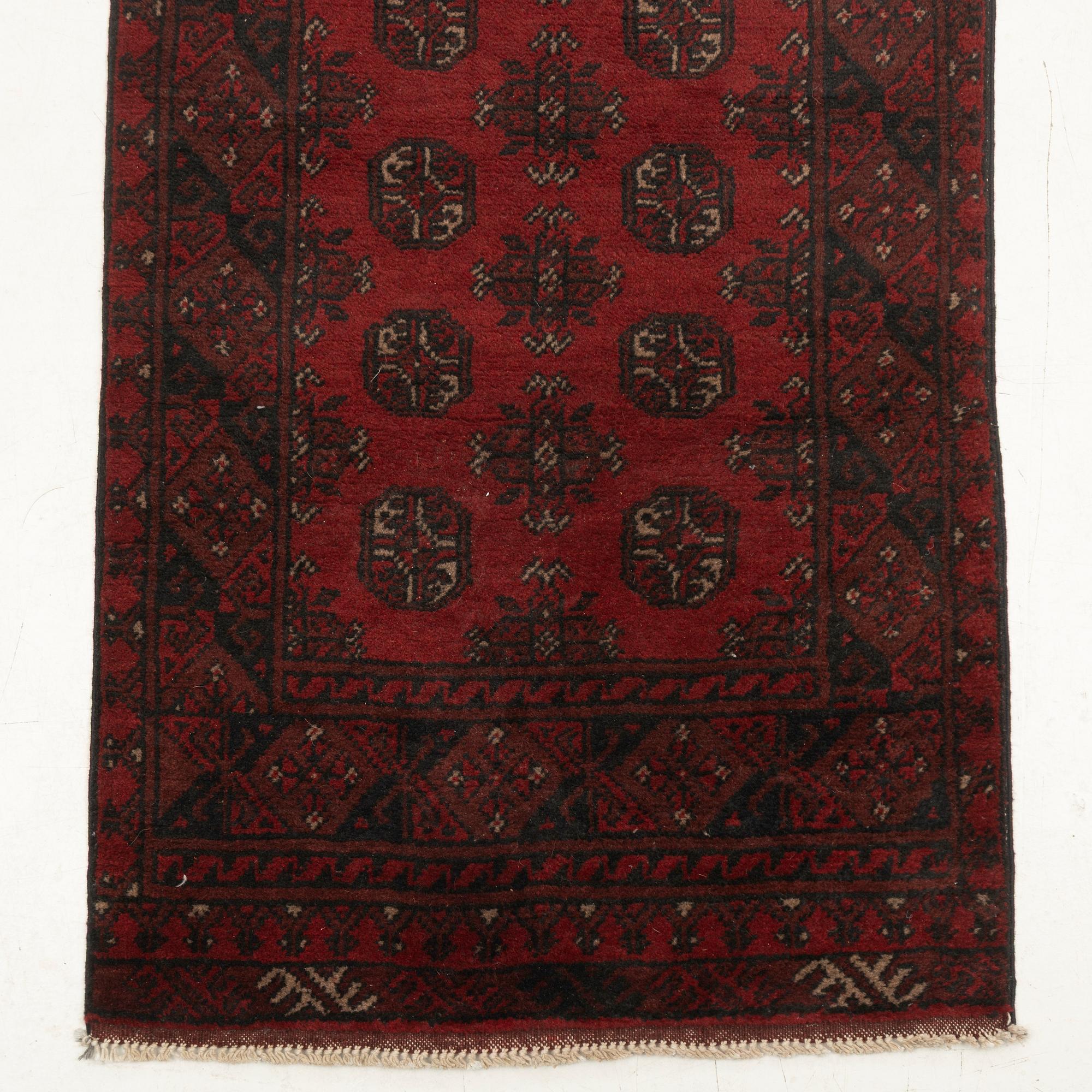 An oriental / Afghan runner, approx. 478 x 81 cm.