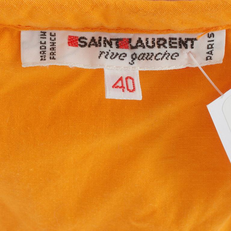 YVES SAINT LAURENT, a orange cotton top and skirt from the 80s.