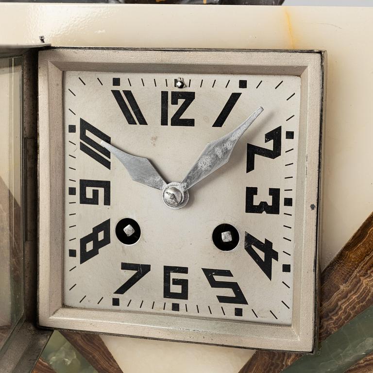 An Art Déco marble mantle clock and a pair of book ends, 1920's.