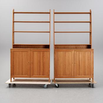 A pair of pine cupboards with shelves by Carl Malmsten.