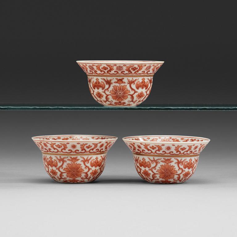 A set of three red lotus cups, Qing dynasty with Daoguangs sealmark and period (1821-50).