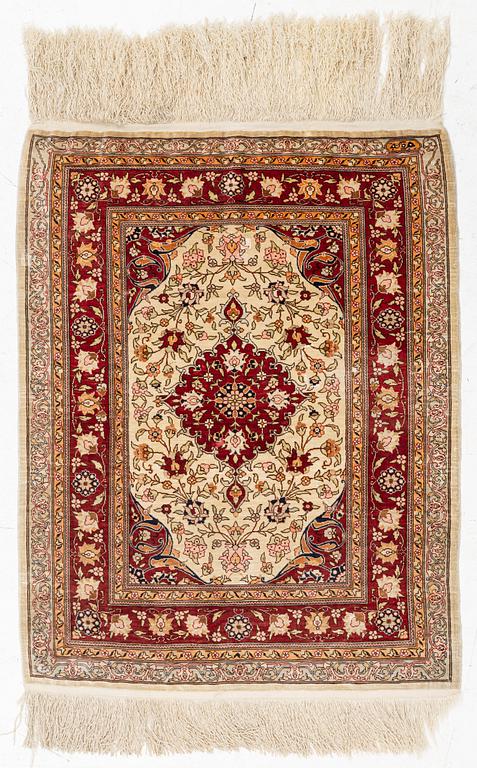 A Silk Hereke Rug, circa 86 x 68 cm.