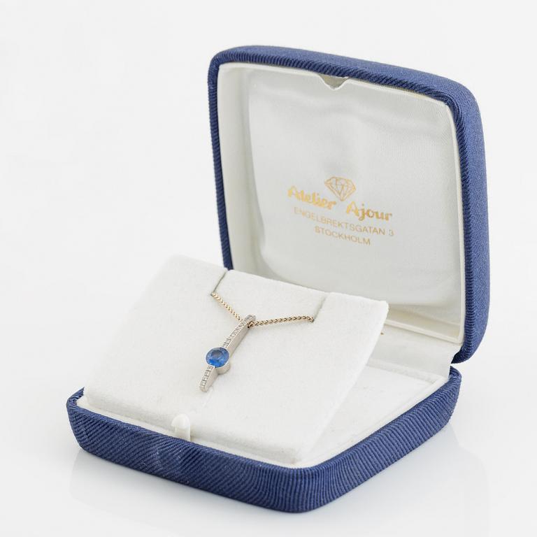 An 18K white gold necklace with a faceted sapphire.