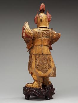A lacquered and gilt wooden figure of a warrior, Qing dynasty, ca 1800.