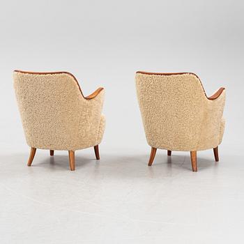 A pair of teak and sheepskin Swedish Modern 1950's easychairs.