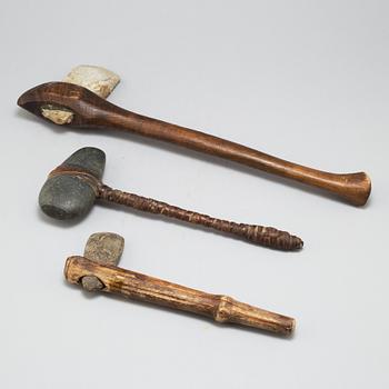 Three stone axes with modern handles.