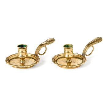128. A pair of rococo brass candlesticks possibly by C. Liendenberg (active in Stockholm from 1745).