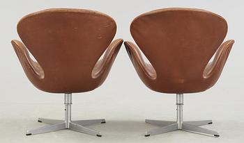 A pair of Arne Jacobsen brown leather 'Swan' chairs, Fritz Hansen, Denmark 1972.