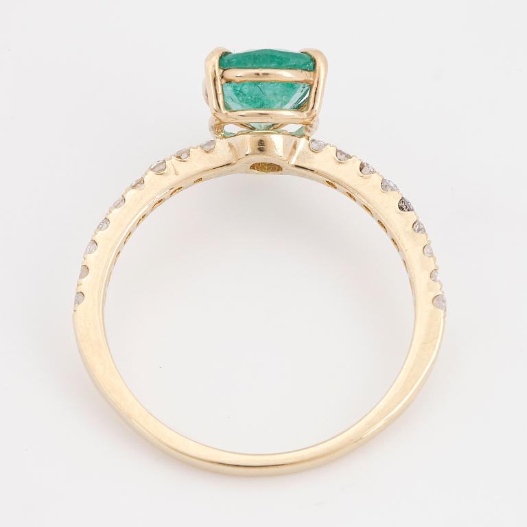 Pear shaped emerald and brilliant-cut diamond ring.