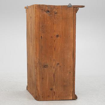 A corner cabinet, 18th Century.