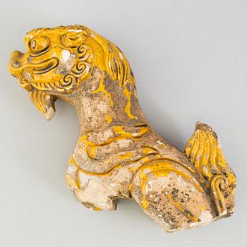 A yellow glazed fragment of a rooftile, Ming dynasty (1368-1644).