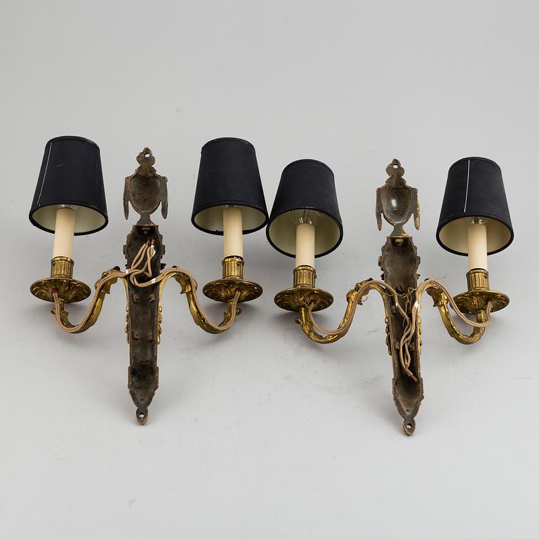 A pair of Louis XVI style wall sconces.