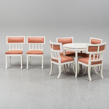 A gustavian style table and six chairs. First half of the 20th century.