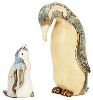 344. Two Gunnar Nylund stoneware figures depicting a penguin mother with child, Rörstrand.