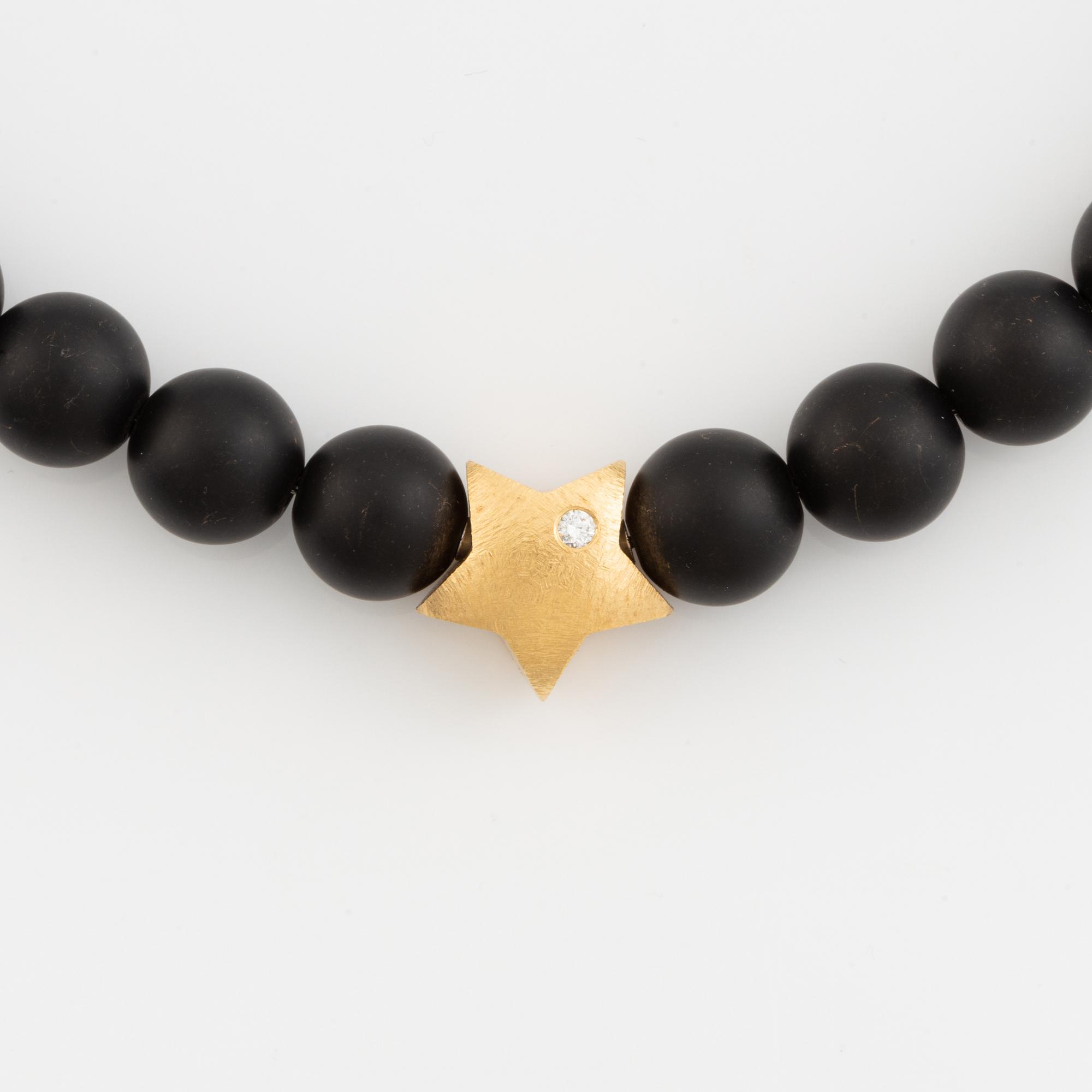 Ole Lynggaard, black stone  bead necklace, clasp star 18K gold with brilliant cut diamond.