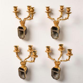 A set of four Empire ormolu and patinated bronze three-branch appliques, Paris, ca 1840's.