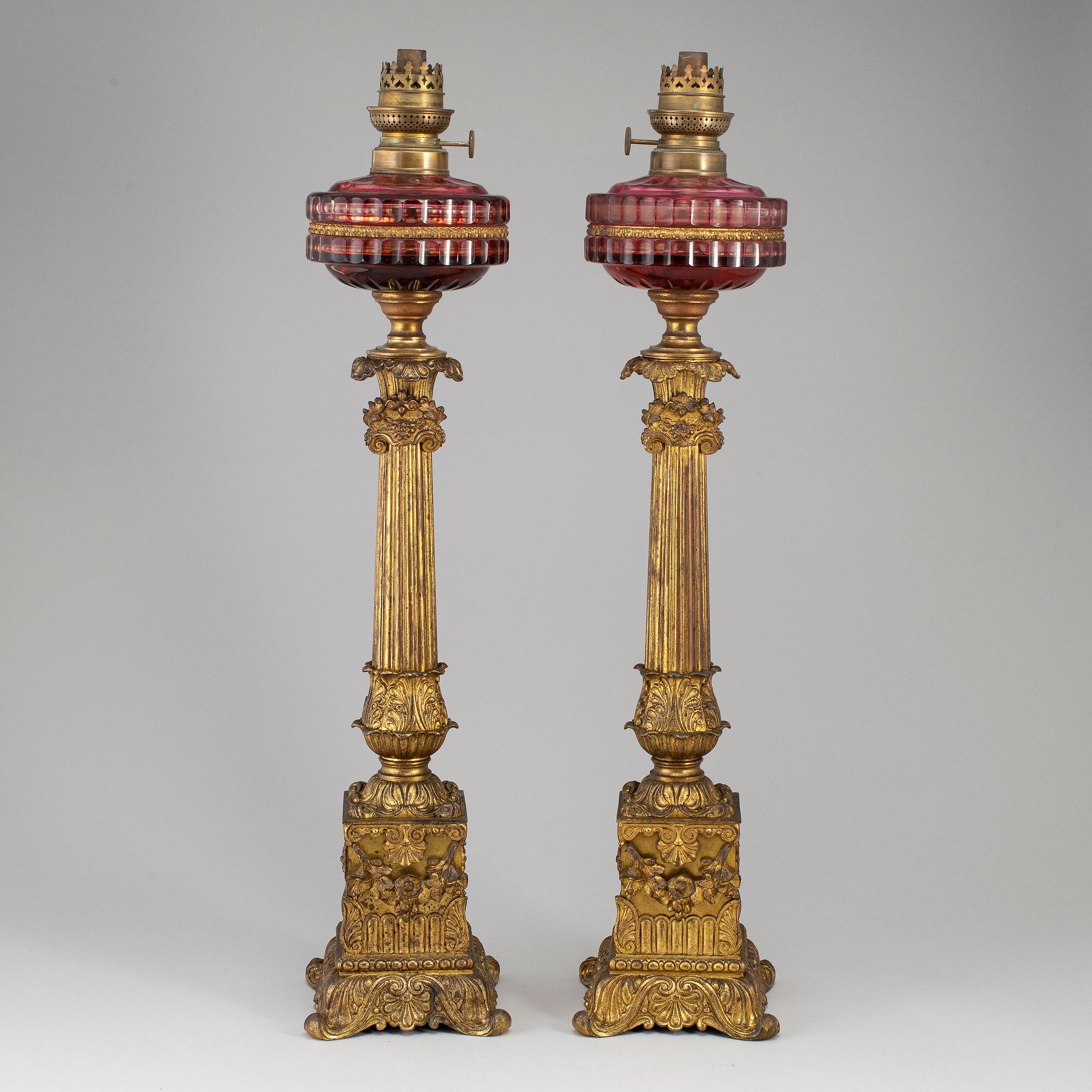 A pair of empire style table oil lamps, bronzed metal and glass, Dublot Freres, Rennes, late 19th century.