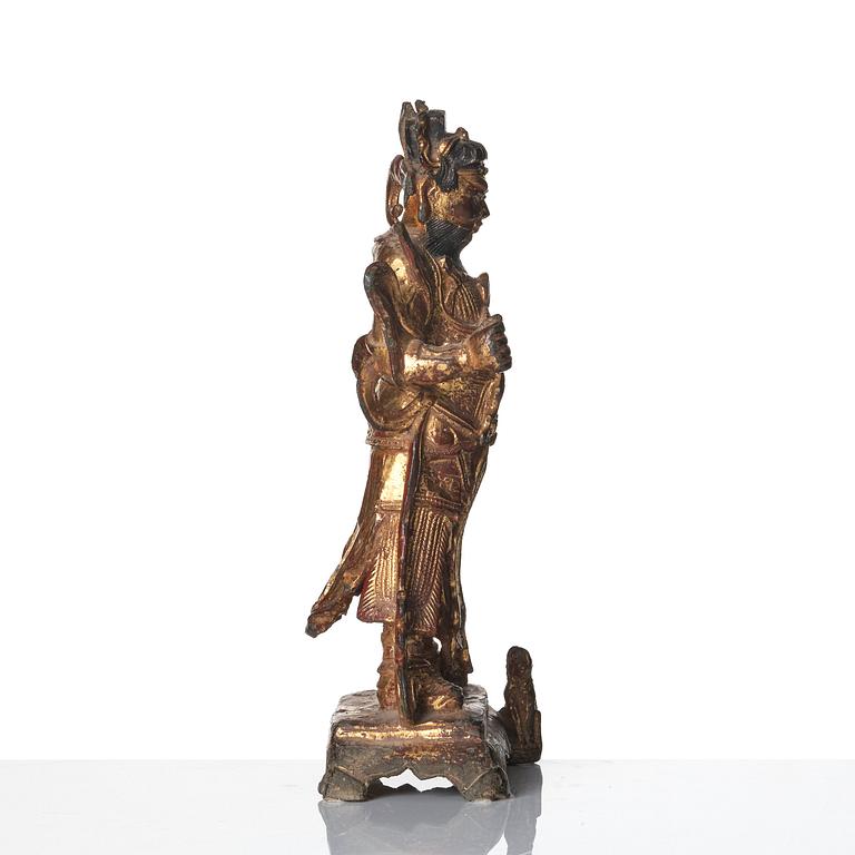 A parcel-gilt bronze figure of a guardian, Ming dynasty (1368-1644).