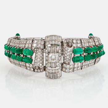 1023. A platinum bracelet set with cabochon-cut emeralds and old-, eight- and baguette-cut diamonds.