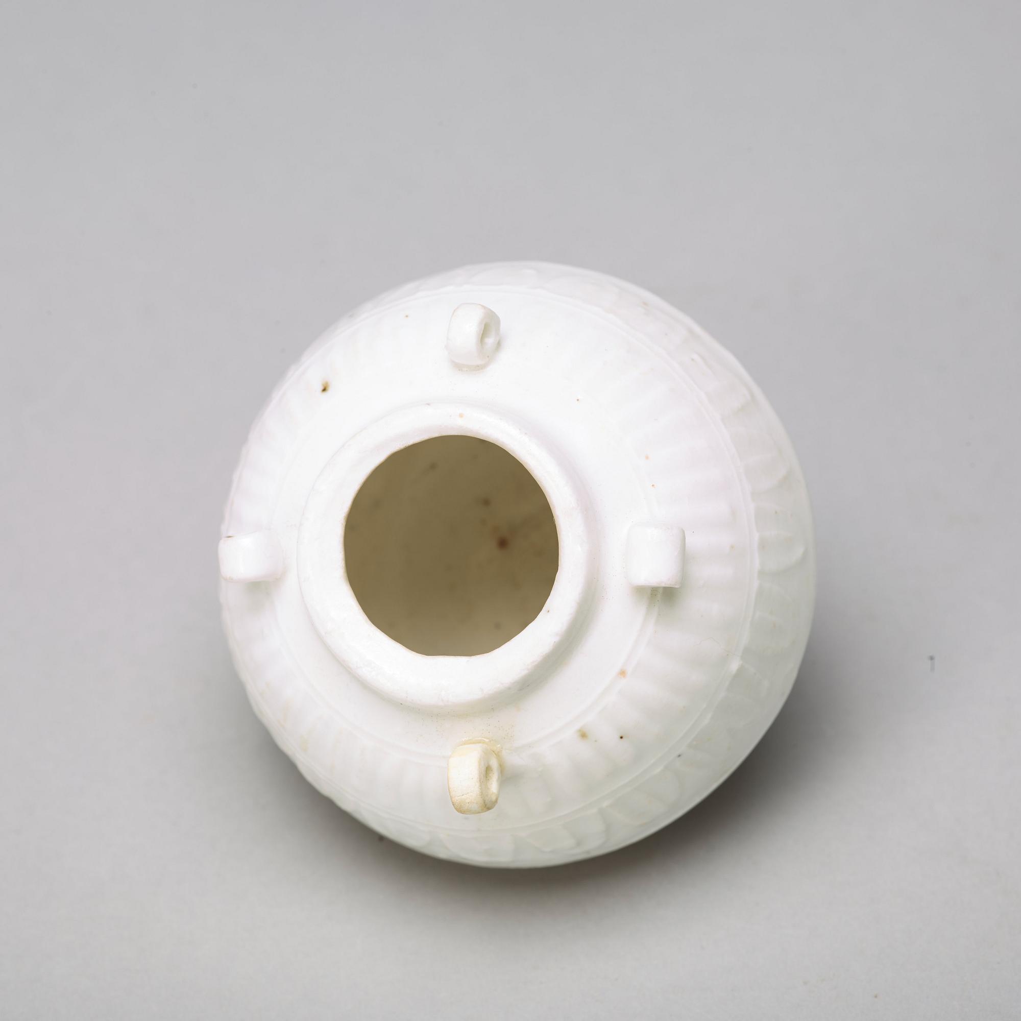 Two celadon glazed dishes and a white glazed jar, South East Asia, presumably 12th/17th Century.