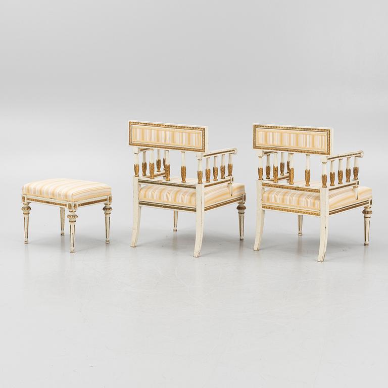 A pair of late Gustavian-style open armchairs and a stool, circa 1900.