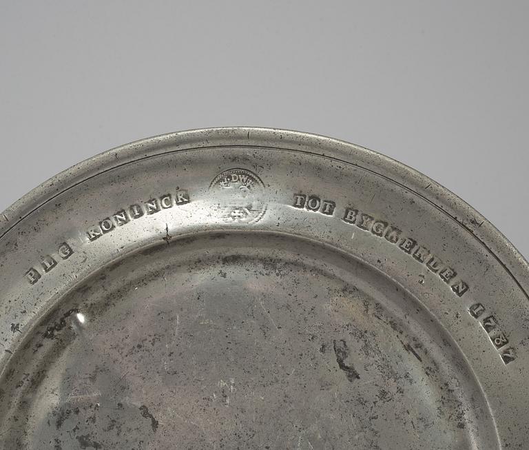A pewter plate, dated 1787.