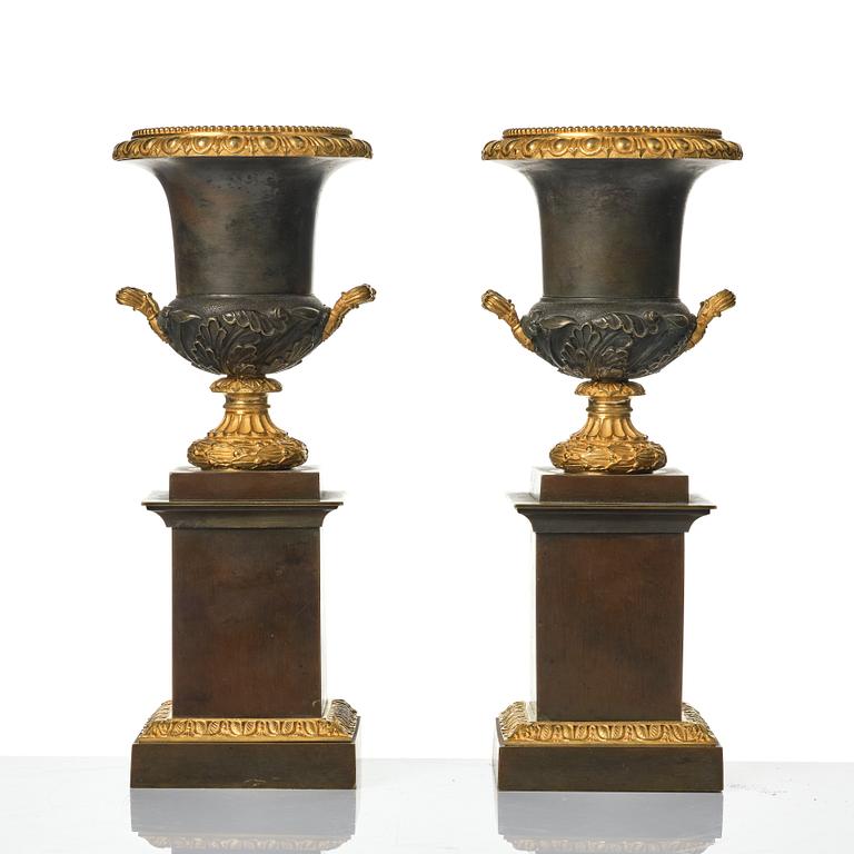 A pair of French Louis Philippe gilt and patinated bronze urns, first part 19th century.
