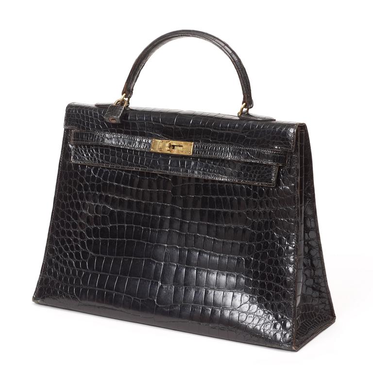 A 1960s/70s black crocodile leather handbag "Kelly" by Hermès.