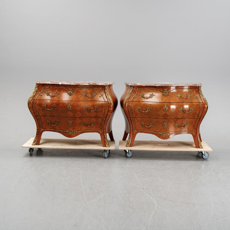A pair of rococo style chest of drawers, mid 20th Century.