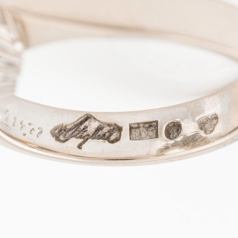 An 18K white gold Engelbert ring set with a aquamarine and round brilliant-cut diamonds.