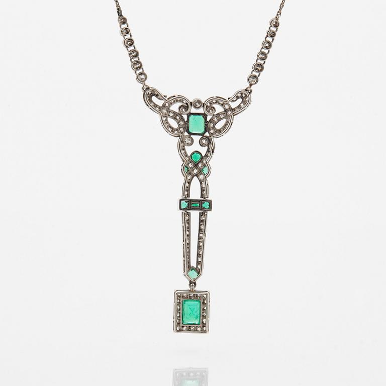 A platinum necklace set with faceted emeralds and old- and eight-cut diamonds.