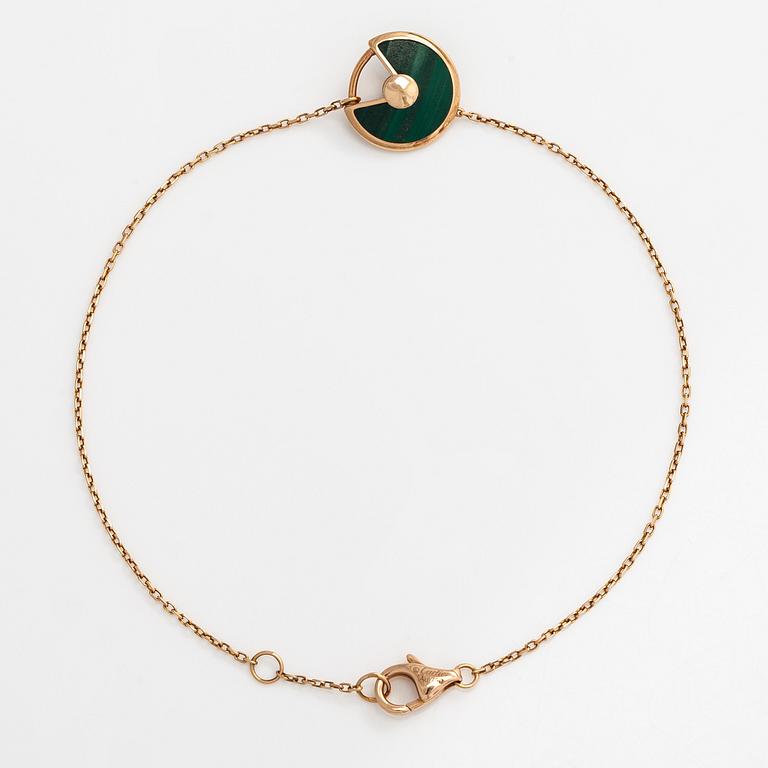 Cartier, an 18K gold "Amulette de Cartier" bracelet with malachite and a brilliant-cut diamond.