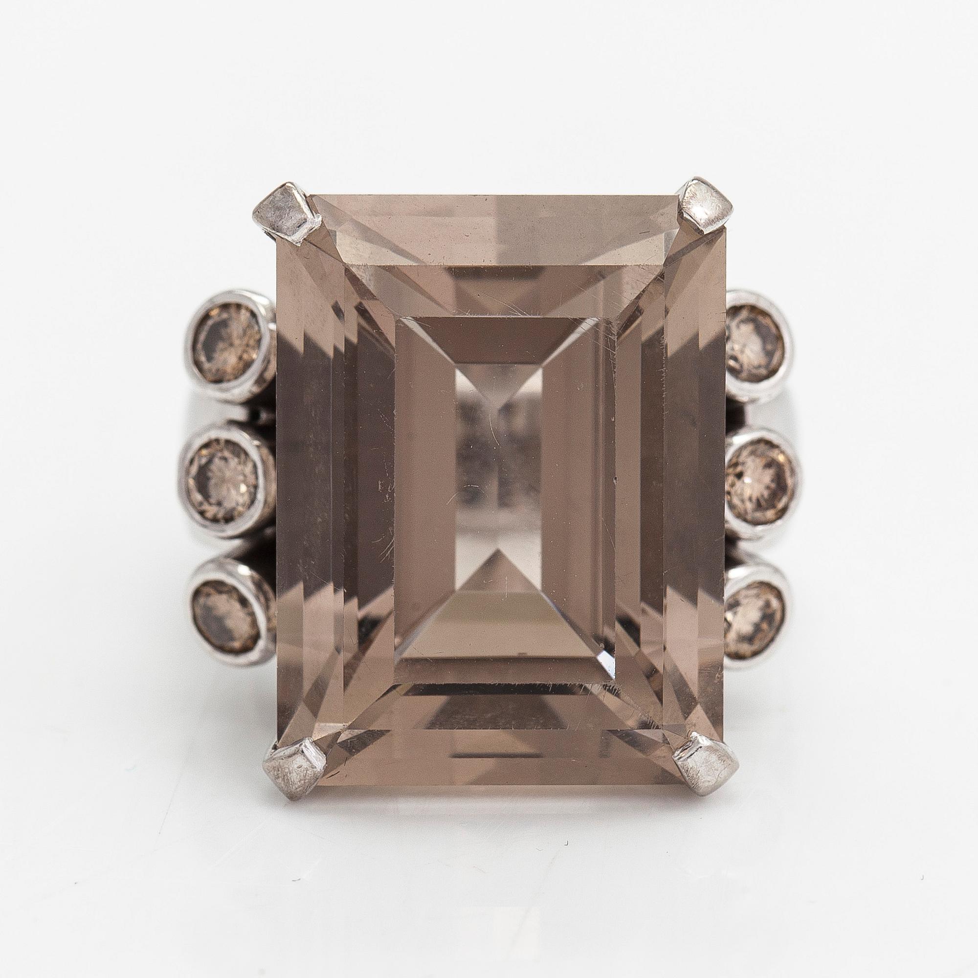 An 18K whitegold ring with an emeraldcut smokey quartz and diamonds approx 0.70 ct in total, Kultala, Helsinki 2008.
