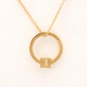 Tiffany & Co, "T" necklace in 18K gold with a baguette-cut diamond.
