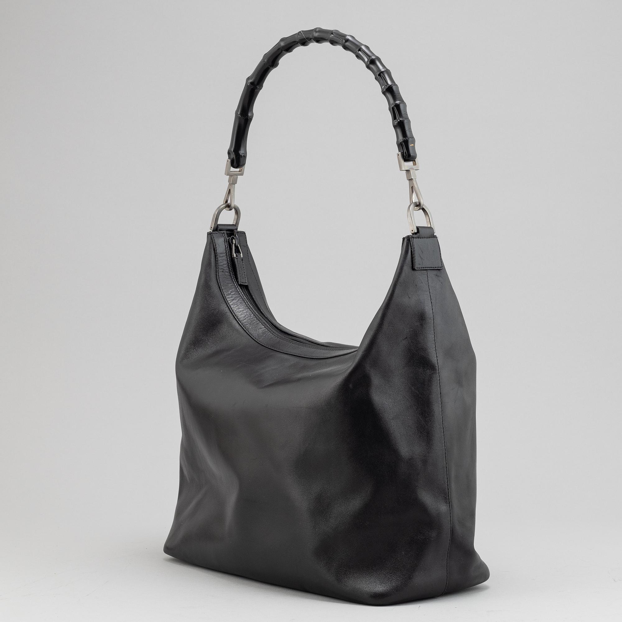 Gucci, a black leather handbag.