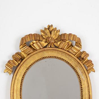 A pair of one-light Gustavian-style giltwood girandole mirrors, late 18th c /resp circa 1900.