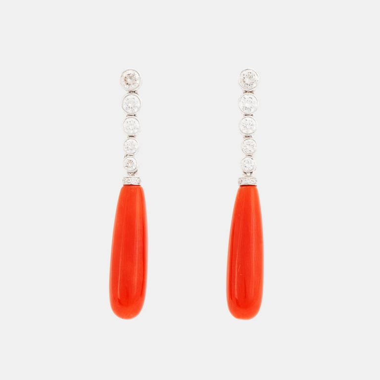 A pair of 18K gold and coral earrings set with round brilliant-cut diamonds.