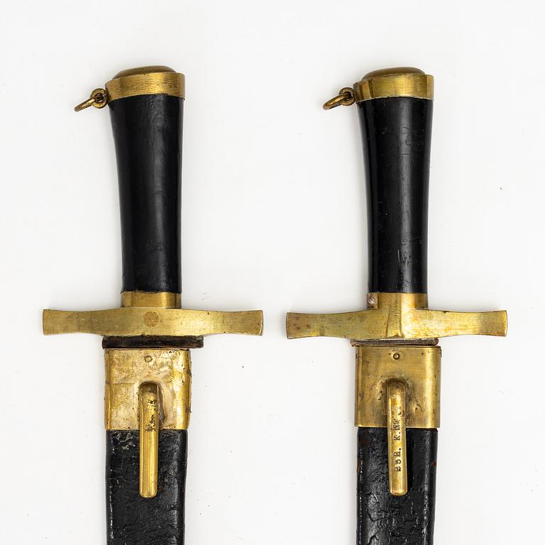 Two Swedish cutlasses 1856 pattern, with scabbards.