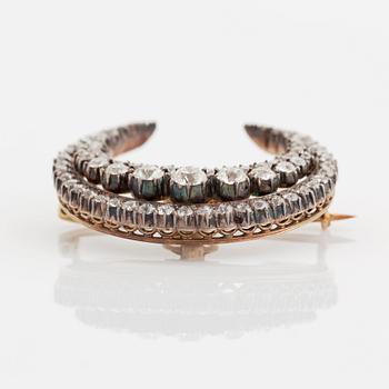 A crescent moon brooch in silver and gold set with old- and rose-cut diamonds.