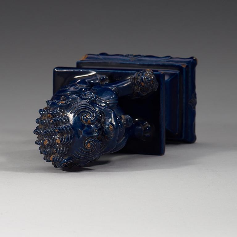 A seated blue glazed buddhist lion, Ming dynasty, 17th Century.