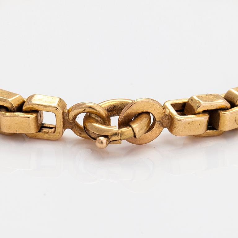 An 18K gold bracelet.