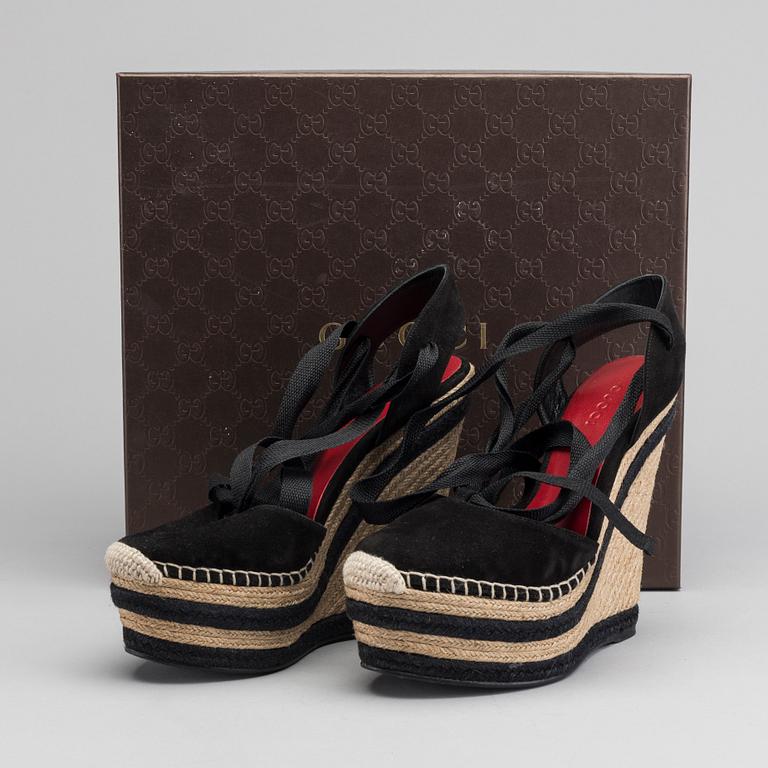 A pair of Gucci wedge shoes size 36.