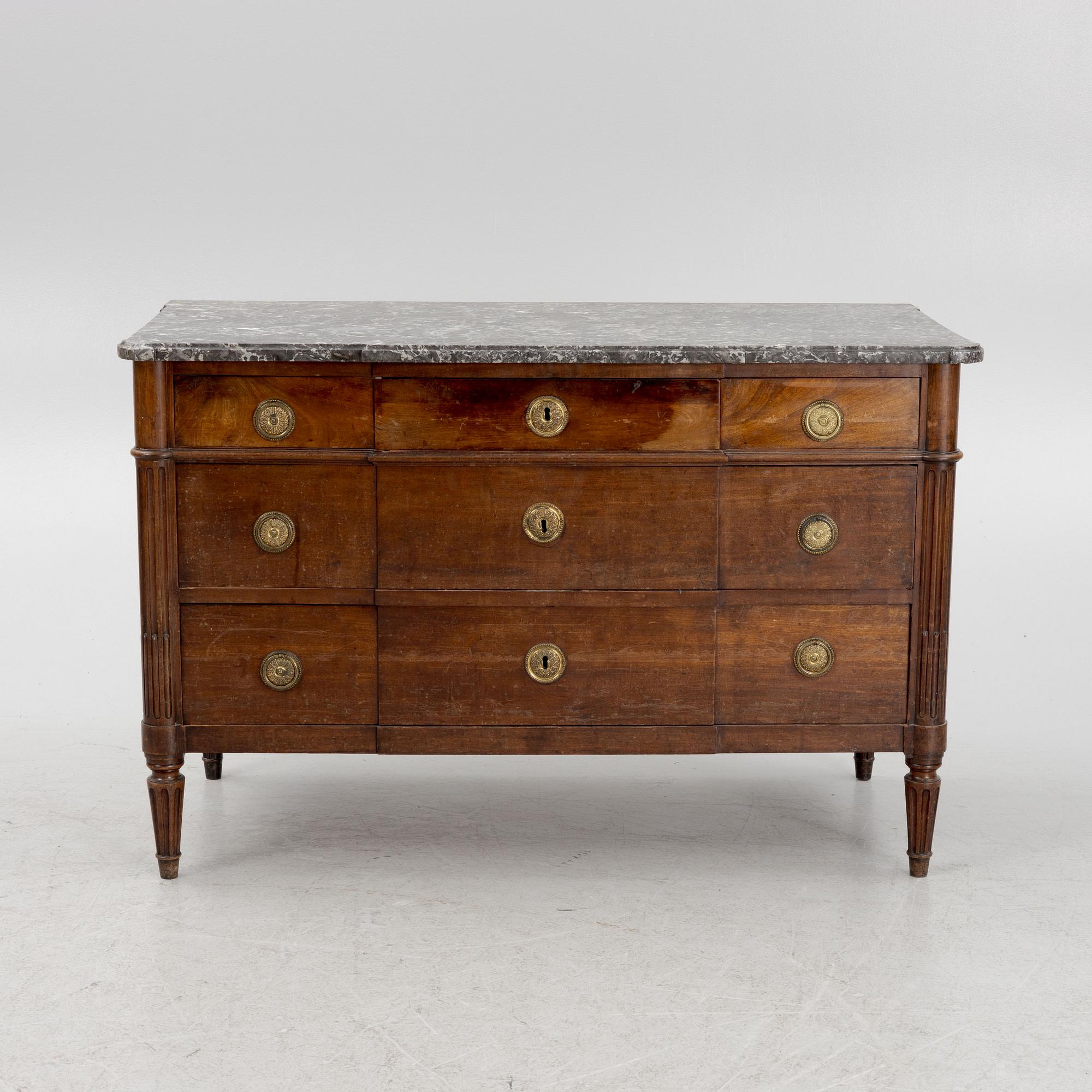 A Franch Directoire mahogany and marble commode, late 18th century.
