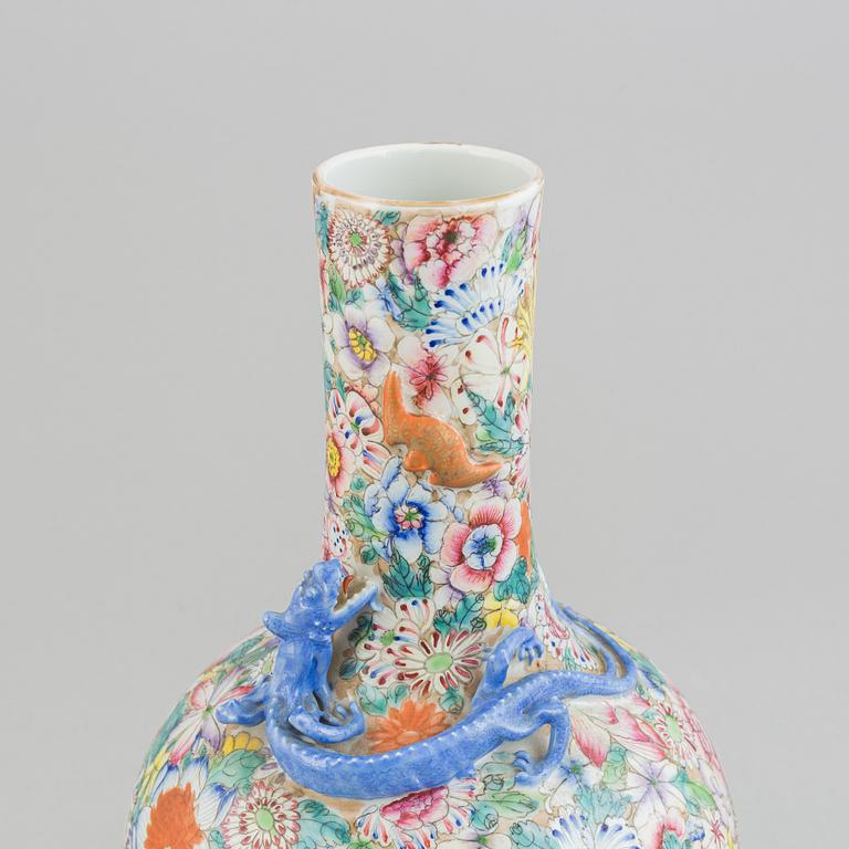 A chinese globular shaped vase, richly decorated with flowers and a dragon and a bat, second half of the 20th century.