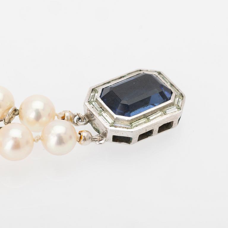 Two-row cultured pearl necklace with a silver and glass clasp.