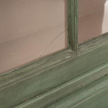 A Rococo cabinet with vitrine top.