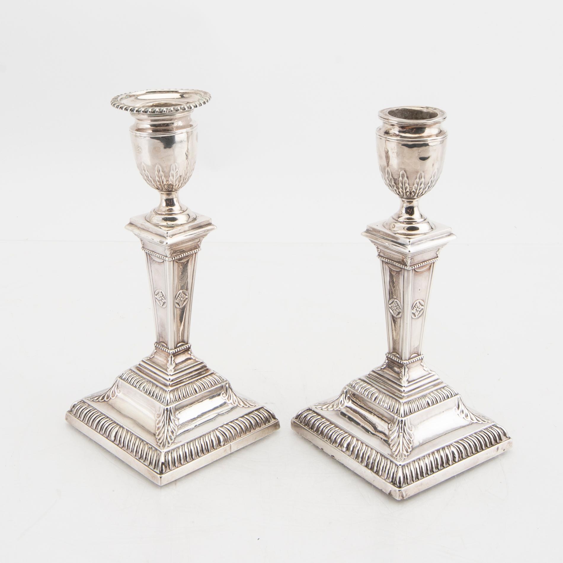 An English 20th century pair of silver candle sticks mark of Mappin & Webb London around 1900.