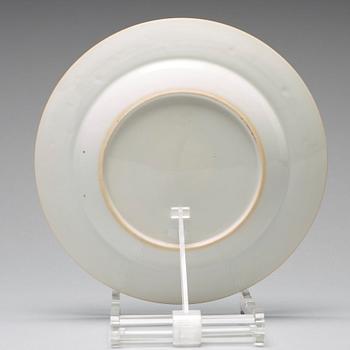 A set of four blue and white armorial dinner plates, Qing dynasty, 18th Century.